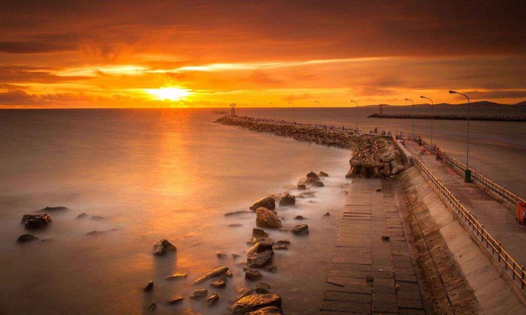 Best beaches in Vietnam — aerial view of turquoise bay with white sand, palm trees, and traditional fishing boats