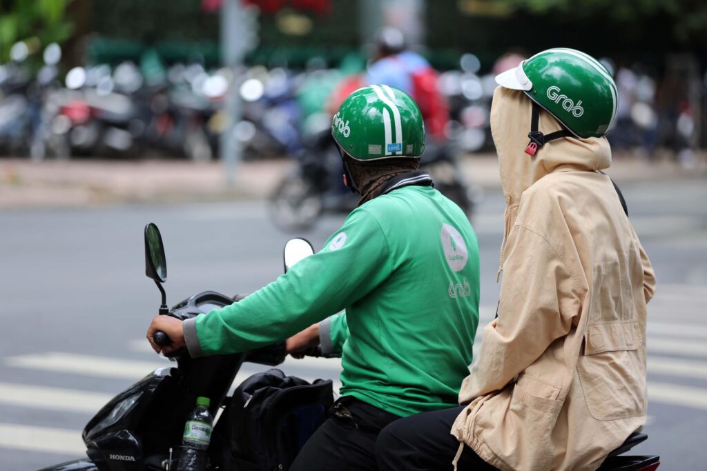 Vietnam motorbike tour — thousand motorbikes flowing through Hanoi Old Quarter intersection at golden hour