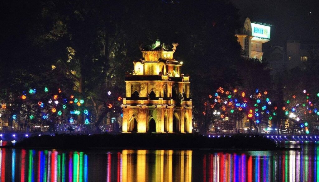 Midnight in Hanoi: Your Ultimate Guide to Late-Night Food, Culture, and Entertainment 5 Midnight in Hanoi — neon-lit Old Quarter street at night with motorbikes and lanterns, Vietnam
