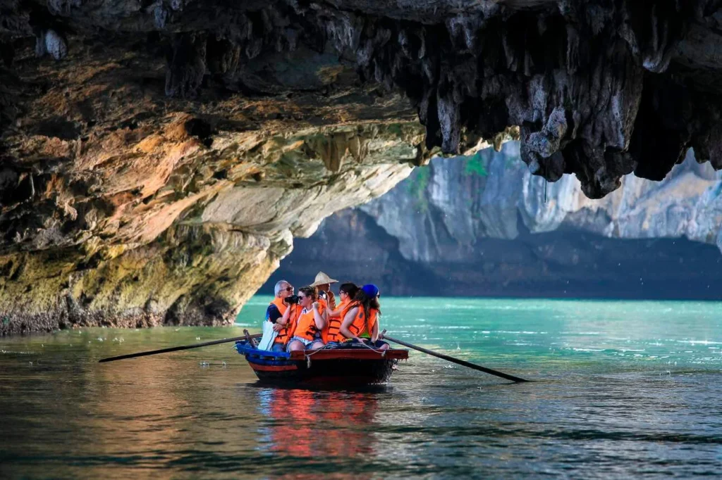 Beyond Halong Bay: Why Lan Ha Bay Is the Better Cruise Experience for Your Clients (And How to Sell It) 2 Kayaking through a sea cave on a Lan Ha Bay cruise