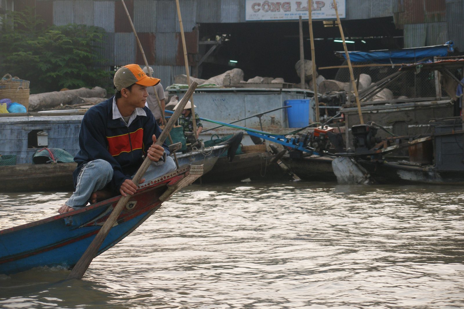 Boatman rowing at the floating market in Can Tho early in the morning
