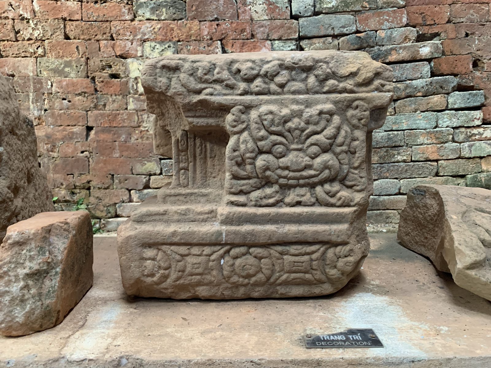 Carved sandstone pedestal displayed at My Son Sanctuary
